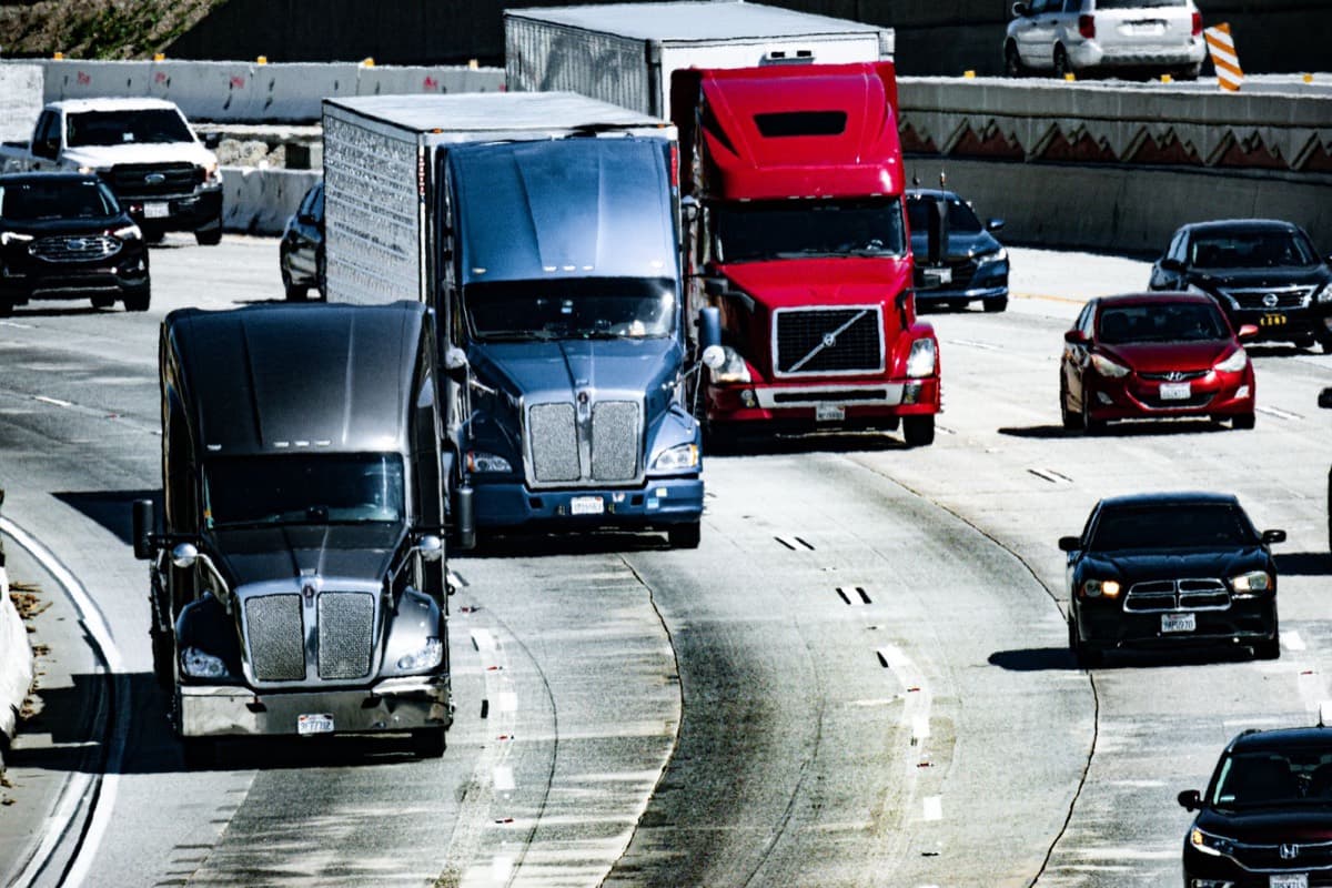 Heavy freight trucks travelling a multi-lane highway